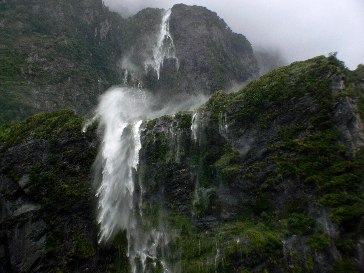 Waterfalls pouring off the fiord walls after heavy rain
